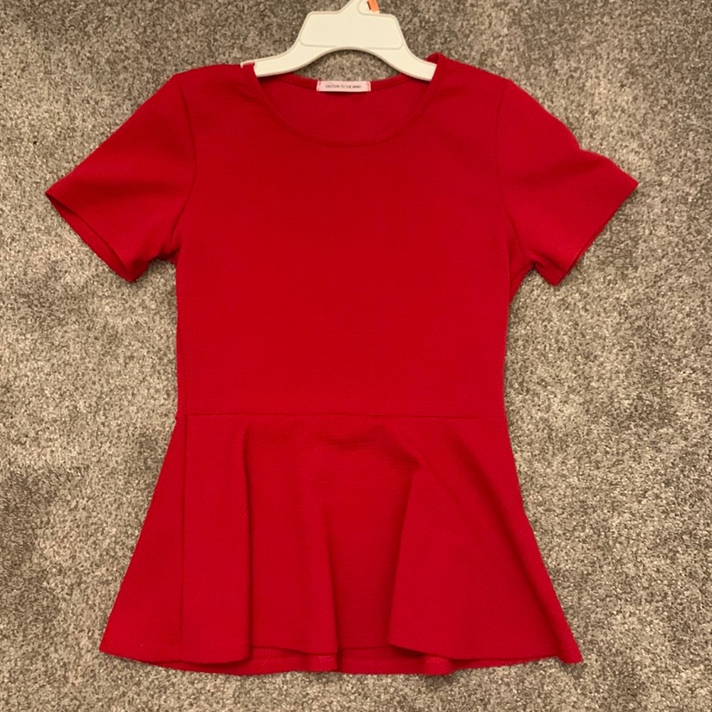 A tight fighting red blouse. Great for a professional activity!